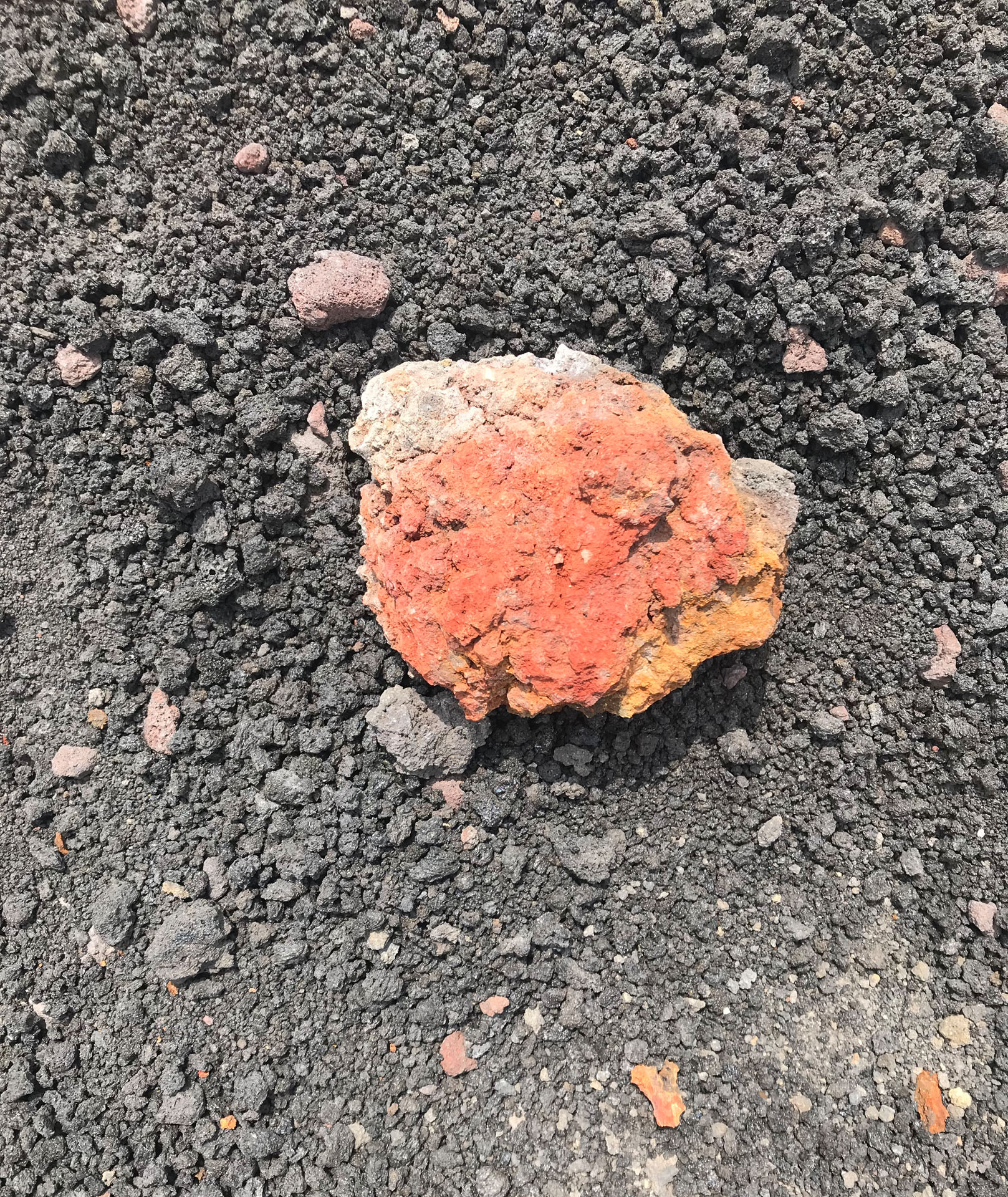 A rock-like form with a peach hue